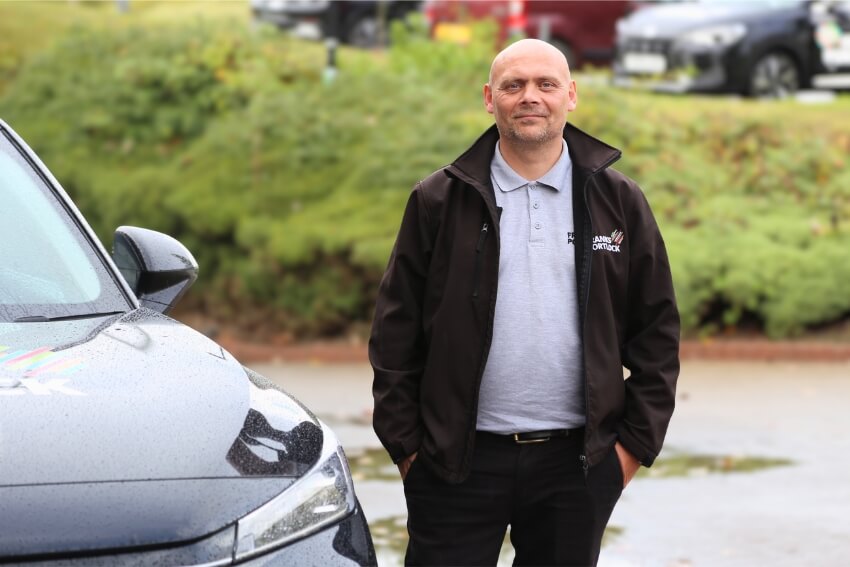 Anthony Carter CoCA, veteran turned asbestos surveyor and regional manager, stood next to fleet car